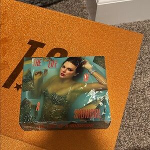 The Life of a Showgirl Keychain, photo, and a cd